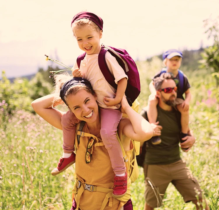 Man and women hiking with their children