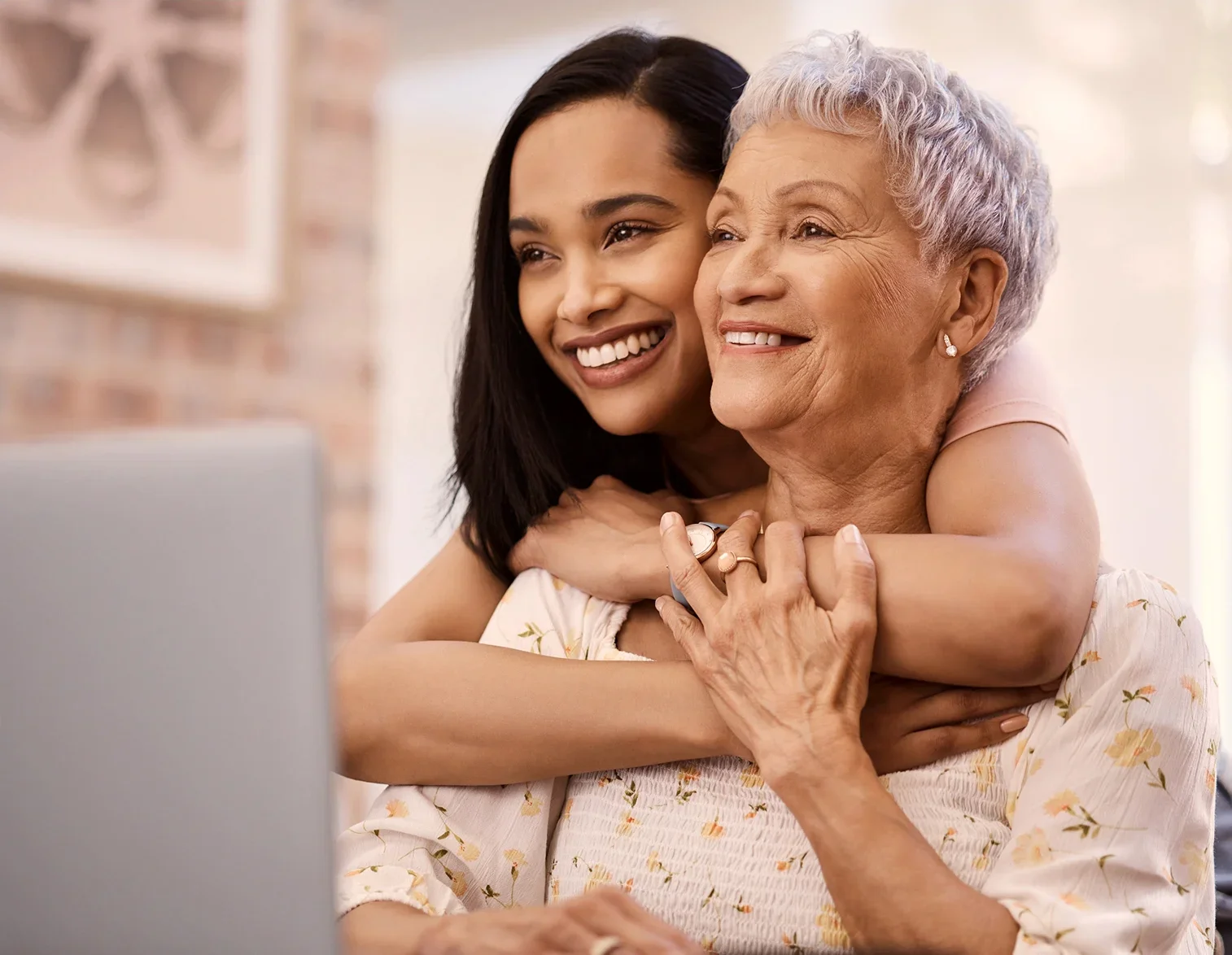 A mom and daughter hugging and smiling